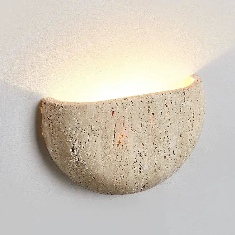 Brenvessa stone wall light with a textured curved surface