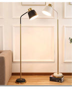 Slim Brass Torchiere Floor Lamp with Tilted Cone Shade and Adjustable Neck | Kelmera